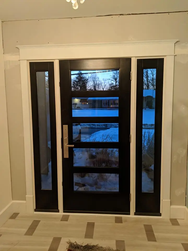 Modern black entry door with full-glass sidelites
