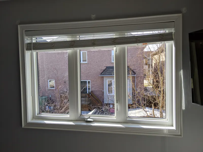 After: the same casement window with clear new sealed glass