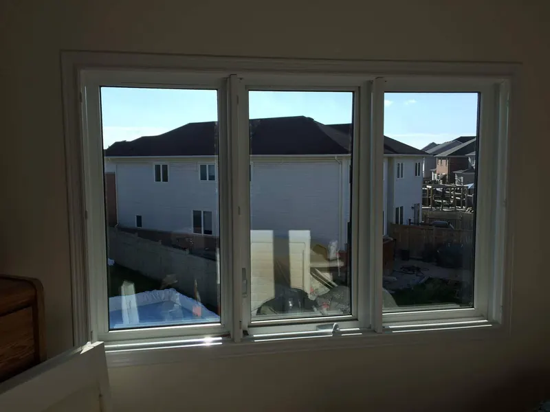 After: the same three-panel window with clear new glass