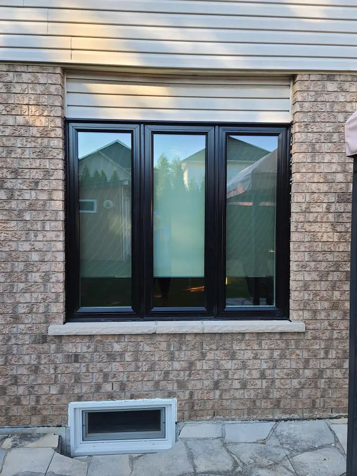 Black-frame vinyl window in a brick wall