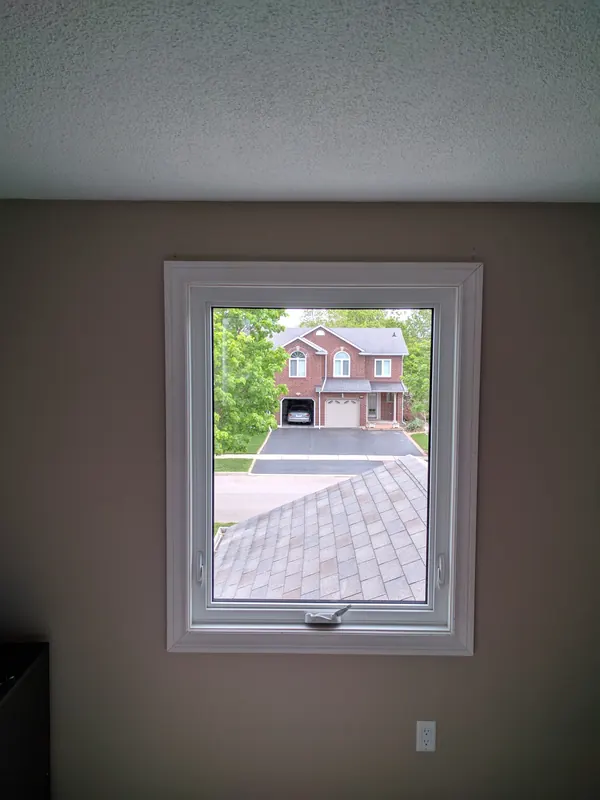 The same window finished with new white trim on the inside wall