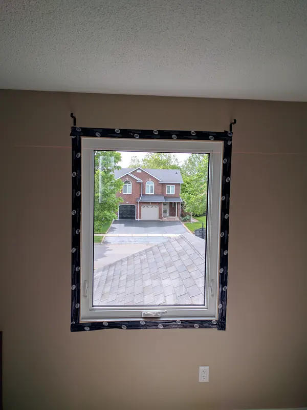 The same window with sealing tape applied around the frame